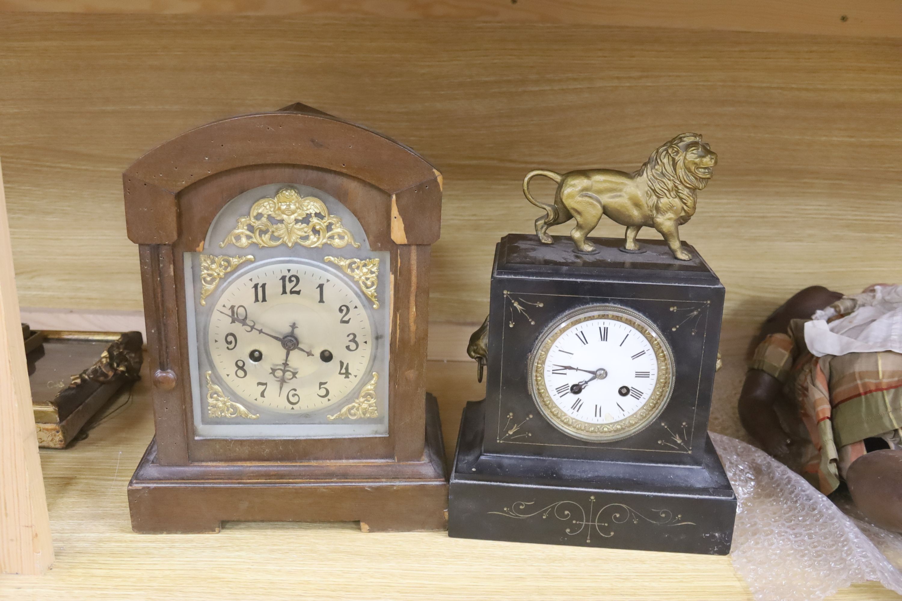 A slate mantel clock with lion surmount and a mahogany mantel clock